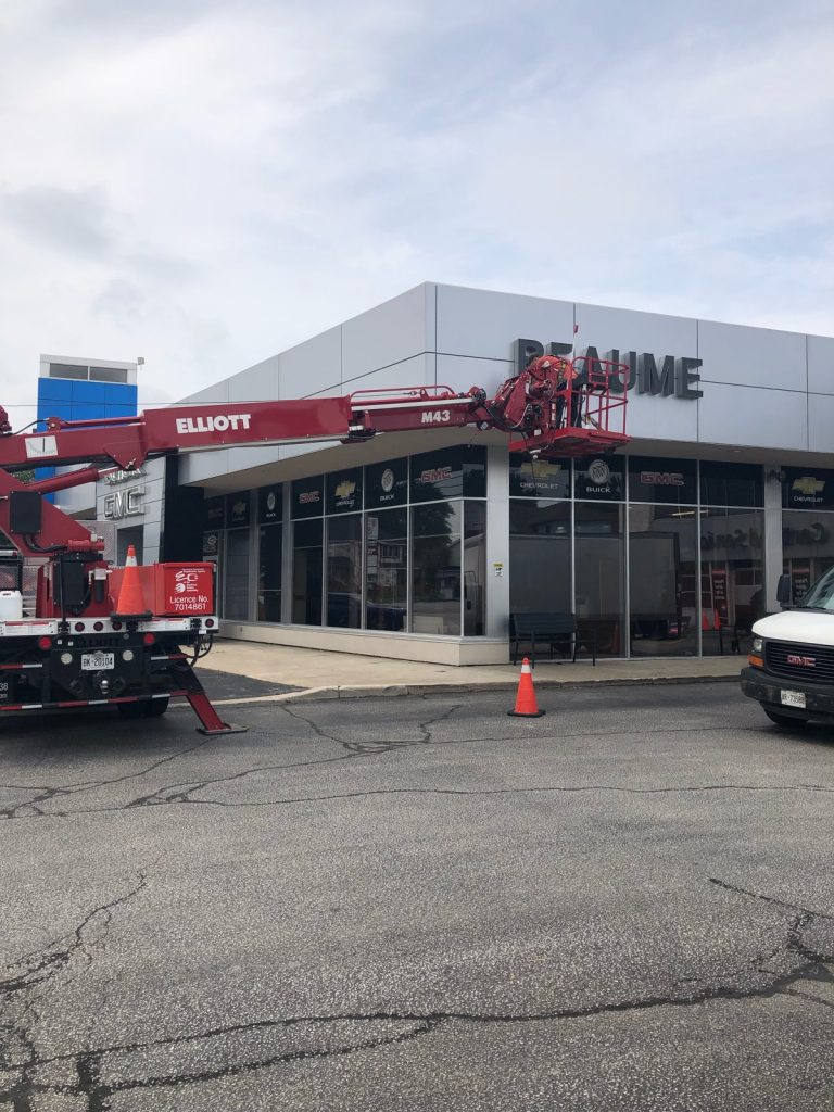 Yesco bucket ladder servicing the building sign for Reaume-Chevrolet Buick dealership